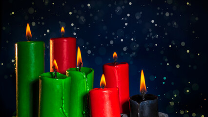 Happy kwanzaa concept with black, red and green candles on dark background, selective focus