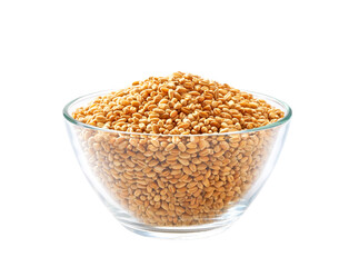 organic wheats in a clear glass bowl isolated on white background.