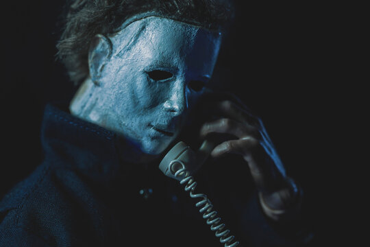 NEW YORK USA: AUG 10 2022: AUG 10 2022: scene from John Carpenters 1979 horror film Halloween, Michael Myers stalking on the phone - custom head sculpt