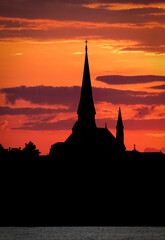 Gorgeous steeple silhouetted sunset.