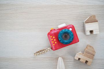 Wooden baby toy camera on wood table.