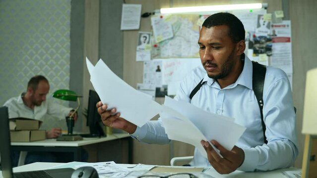 Angry detective reached dead end on investigation. Furious police officer crumples paper and throws away files, unbuttons his shirt and swears. High quality 4k footage