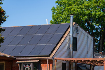 Modern houses with solar panels on the roof for alternative energy.