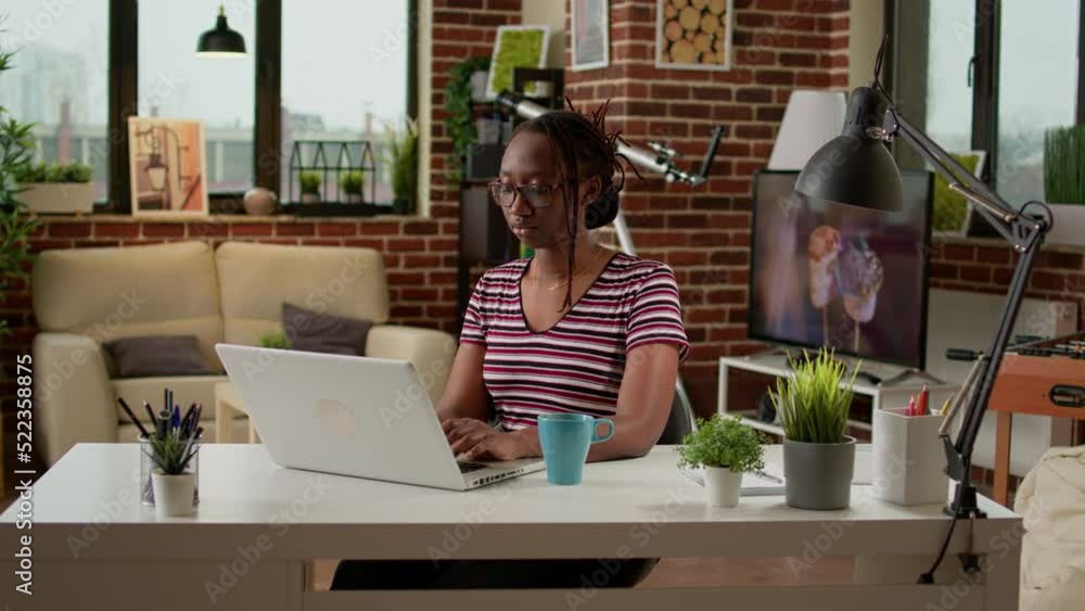 Poster company employee browsing internet to do remote work on laptop, using computer to take notes. freela