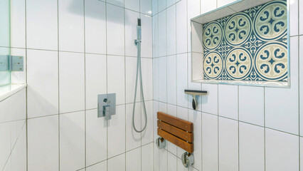 Panorama Shower stall interior with white ceramic tiles surround and cement tiles with blue patterns