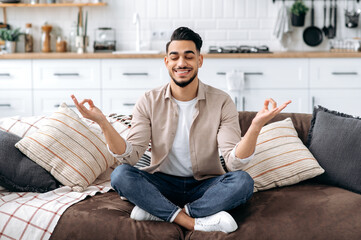 Relaxation and meditation concept. Happy peaceful relaxed indian or arabian man in casual clothes,...