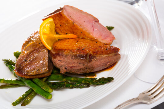 Top view of roasted duck breast with asparagus. High quality photo