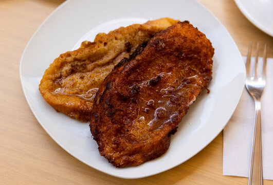 Delicious toasts torrijas - traditional Spanish Easter dish from bread soaked in milk with honey and spices and sprinkled with cinnamon..
