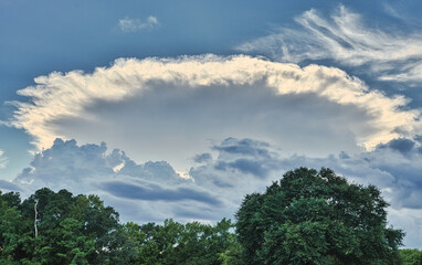 A dramatic round cloud and backlit sky that resemble an alien mothership UFO!