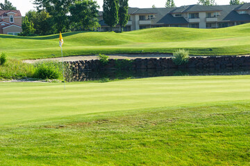 Golf pin flag on golf course green
