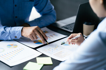 Business team reviewing a diagram or chart and financial reports for a return on investment or investment risk analysis or business performance. - obrazy, fototapety, plakaty