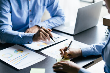 Business team reviewing a diagram or chart and financial reports for a return on investment or investment risk analysis or business performance.
