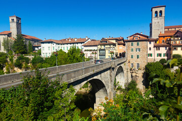 View of historic centre of Cividale del Friuli with medieval stone Devil Bridge (Ponte del Diavolo) over Natisone river, Italy