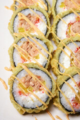 Sushi on a white plate in tempura salmon and pepper. Food.