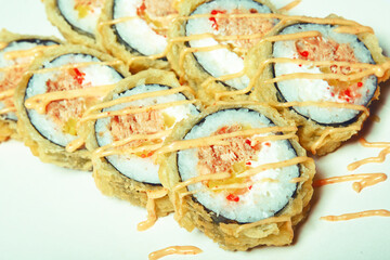 Sushi on a white plate in tempura salmon and pepper. Food.