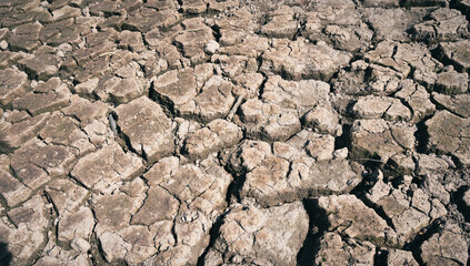 Dried cracked earth soil ground texture background, pattern of drought lack of water of nature old broken.