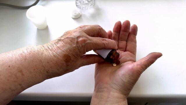 Close Up Top View Of Older Woman Taking Daily Dose Of Medications Antibiotic Aspirin Pill At Home, Feel Unhealthy, Sick Mature Female, Elderly Healthcare Concept. Vitamins, Pharmacy, Selective Focus