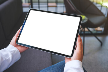 Mockup image of a woman holding digital tablet with blank white desktop screen