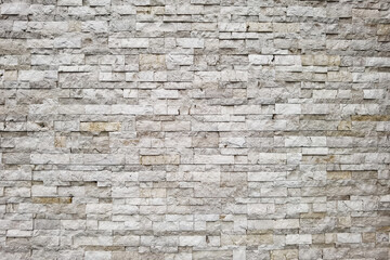 close up of stone wall brown mosaic tiles of background.
