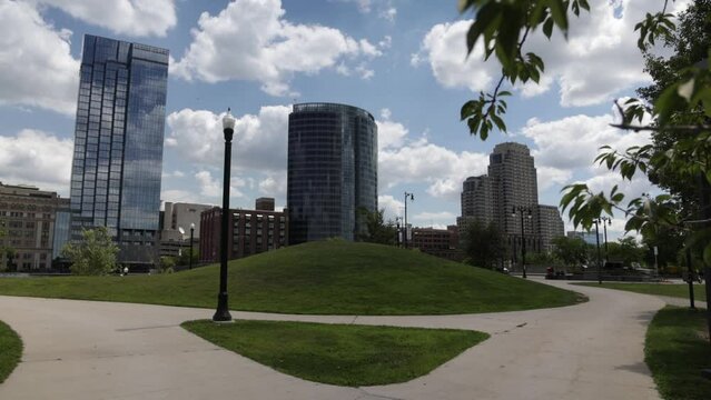 Grand Rapids, Michigan downtown gimbal video walking forward through trees on cloudy day.