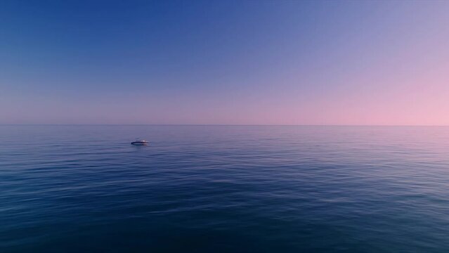 Aerial view of Mediterranean sea during dusk hours with boat in the horizon