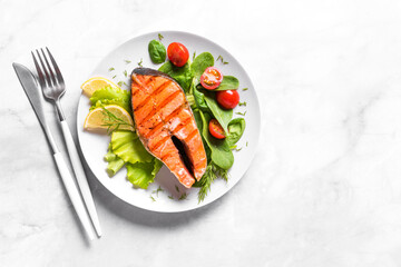 Grilled salmon steak with vegetable salad