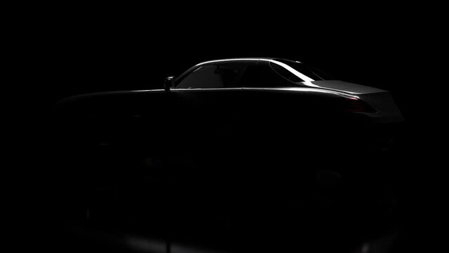 The silhouette of the car slowly emerges from the darkness.