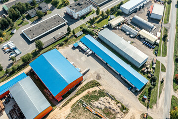 aerial view of goods warehouses. logistics center in suburb industrial area. drone point view.