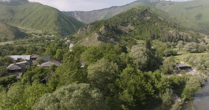 Flying Over Small Village Nestled In Forested Mountains In Daba, Georgia. Aerial Drone Shot