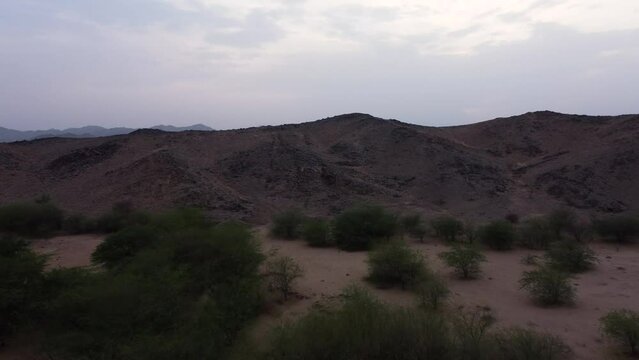 Aerial flying over deserted landscape revealing Al Lith hot spring