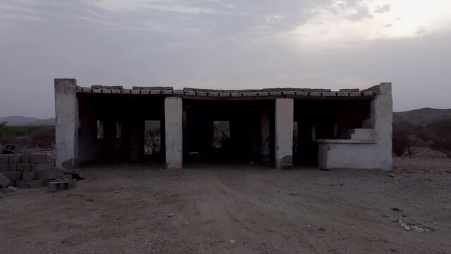 Aerial flying into construction debris revealing landscape around Al Lith fly through the window