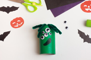 Step by step photo instruction Halloween craft. Step Handmade decoration monster from toilet paper roll. Reuse concept