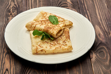 delicious juicy pancakes lie on a white plate