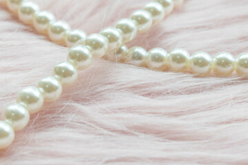 Pearl beads on the pink fabric with copy space.