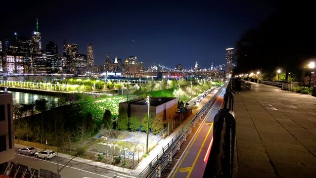 Hyperlapse of cars passing by on the BQE with the NYC skyline in the back at night time.