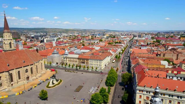 Aerial drone view of Cluj centre, Romania. Cityscape, walking people, road with cars, old buildings, Saint Michael Church