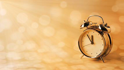 vintage alarm clock in golden sunlight rays, copy space