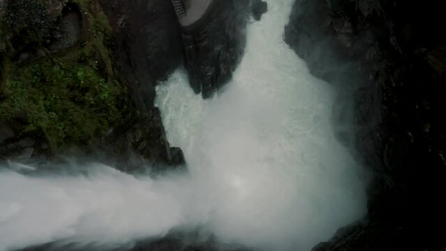 Powerful Pailon Del Diablo Waterfall In Ba&ntilde;os de Agua Santa, Ecuador - drone descending
