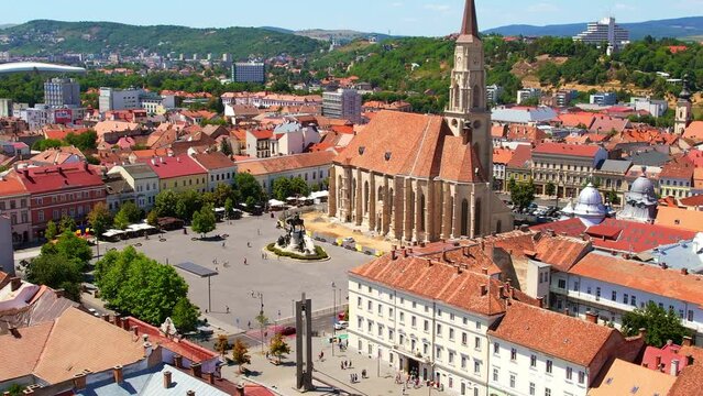 Aerial drone view of Saint Michael Church in Cluj, Romania. Cityscape, central square, old buildings, cars