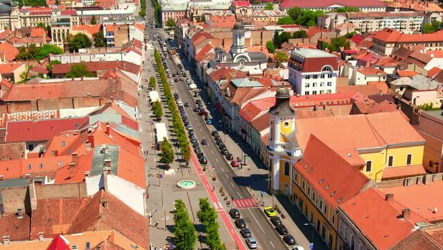 Aerial drone view of Cluj centre, Romania. Cityscape, walking people, road with cars, old buildings