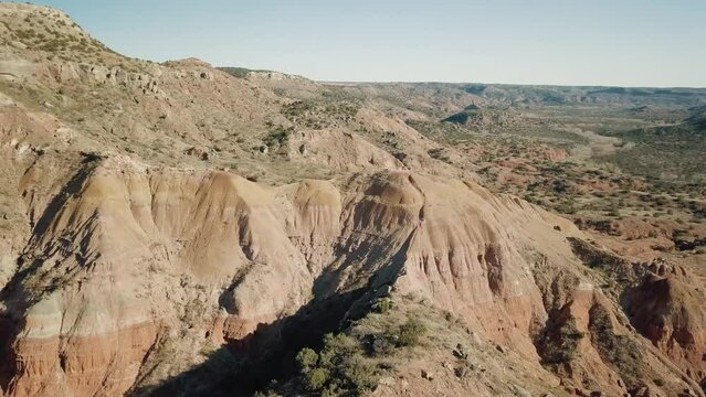 An orbit aerial shot of a high point area in palo duro canyon.