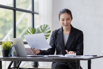 Business Asian woman working at office with documents on his desk, doing planning analyzing the financial report, business plan investment, finance analysis concept