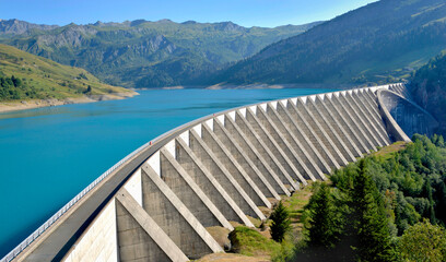 the roselend dam with turquoise water in a mountainous landscape in France - Powered by Adobe