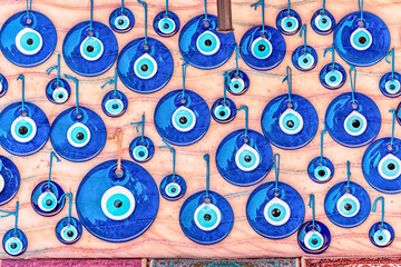 Evil eye turkish bead amulets hanging in souvenir store. Gift and superstitions concept