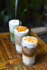 Coffee beverages with coffee beans on wooden table in a coffee shop