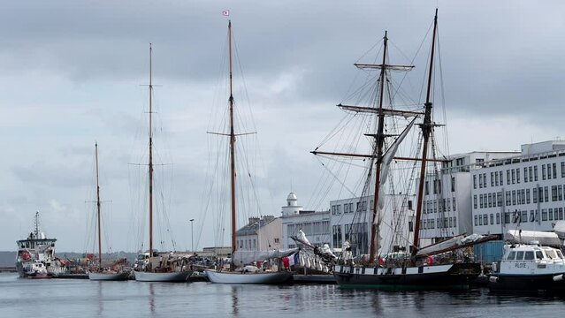 Sailboats and wooden tall ship docked in Brest, France harbor