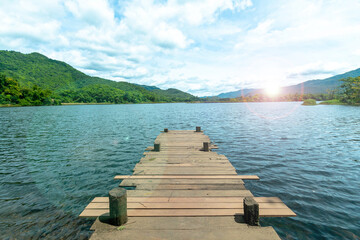  Wooden bridge  with the lake mountain and sky landscape. Wood floor with lake mountain and sky of nature park background and summer season