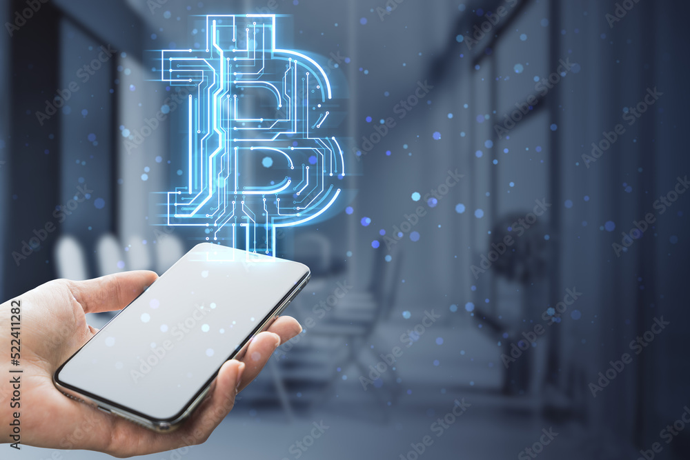 Poster hand holding empty smartphone with creative glowing bitcoin circuit hologram on blurry office interior background with mock up place and bokeh circles. Cryptocurrency, blockchain and finance concept. 