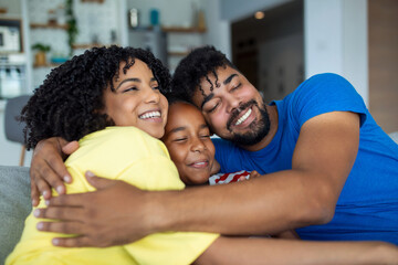 Obraz premium Happy Family Portrait. Smiling parents and their cute little daughter hugging and posing together.