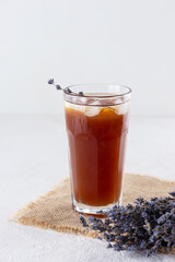 Cold cocktail with ice and lavender in a glass.